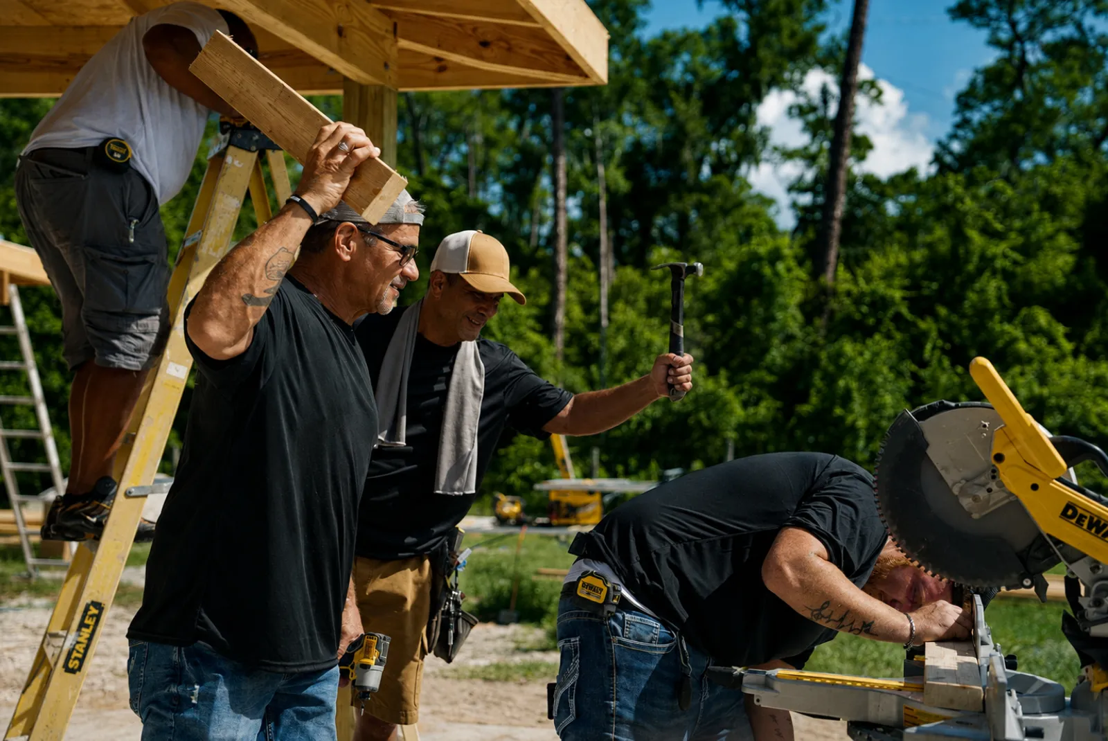 Flooring services in Lake Wales, FL · FTK crew carrying lumber on site