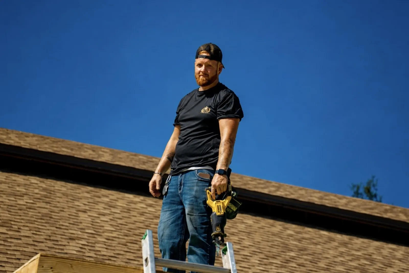 Home remodeling in Bartow, FL · FTK crew member on a ladder at the roof edge