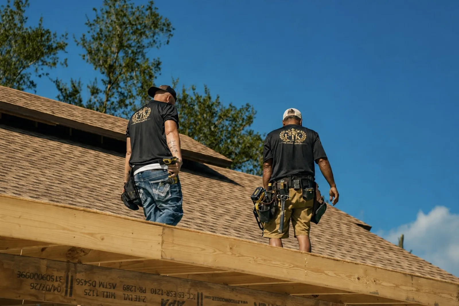Home remodeling in Lakeland, FL · FTK crew members walking a roofline during a project